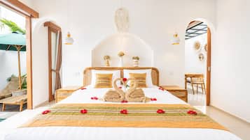 Un dormitorio amplio con una cama grande, cabecera de madera y un cenicero decorativo con forma de cisne.
