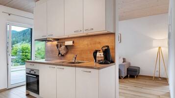 Fridge, dishwasher, coffee/tea maker, cookware/dishes/utensils