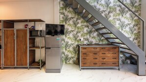 A modern kitchen with a built-in microwave, a refrigerator, and a wooden cabinet. - Lofty Comfort Stay-Relax by Soben Home (Phnom Penh)