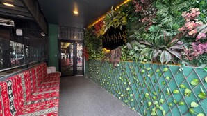 A boutique hotel entrance with a patterned bench, a green lattice wall, and a sign reading "MIYANA boutique". - Viyana Boutique Otel (Kutahya)