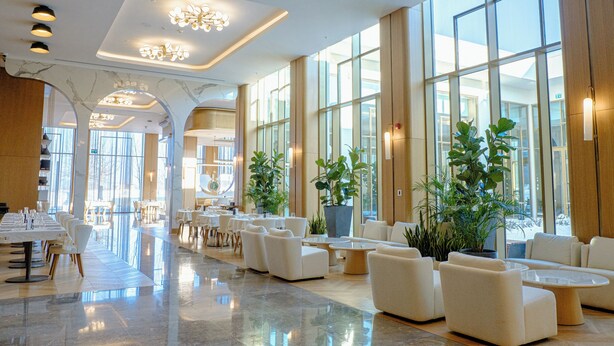 A spacious lobby with a long reception desk, multiple seating areas, and large windows allowing natural light. - Shusha Hotel & Conference Center (Shusha)