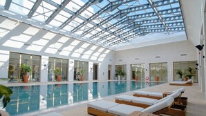 An indoor swimming pool with sunlit rooms and lounge areas. - Shusha Hotel & Conference Center (Shusha)