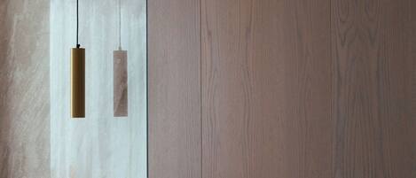 A wooden door with a brass handle and a small rectangular cutout.