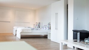 Un dormitorio moderno con una cama, un armario y un escritorio.