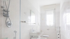 A modern bathroom with a glass-enclosed shower, a freestanding bathtub, a sink, and a toilet. - Bijoux in the Centre of Sanremo by Wonderful Italy (Sanremo)
