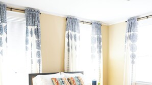A neatly arranged bedroom with a large bed, a bedside table, and a nightstand. - Close to what brought you here, quiet when you get back. A comfortable 2BR where work trips, longer stays, couples, and pets can settle into Montgomery without living like travelers. (Montgomery)