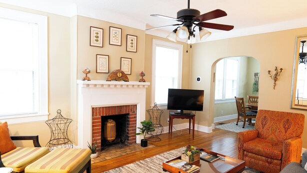 A living room with a fireplace, a television, and a dining area. - Close to what brought you here, quiet when you get back. A comfortable 2BR where work trips, longer stays, couples, and pets can settle into Montgomery without living like travelers. (Montgomery)