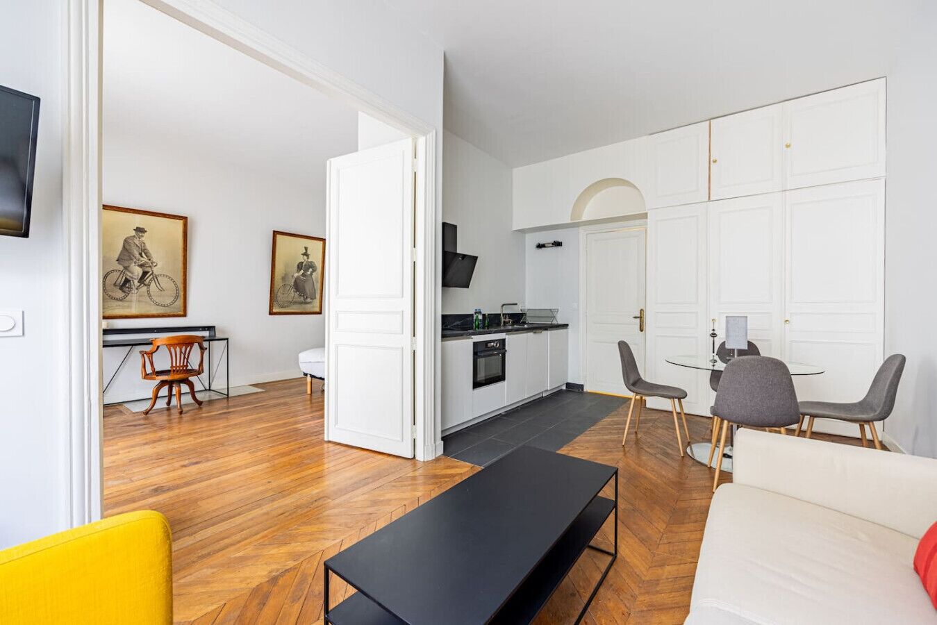 A modern apartment with a kitchen, dining area, and living room.