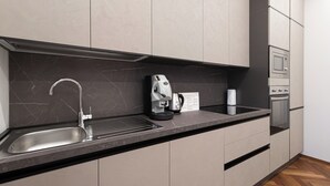 A modern kitchen with a built-in sink, a coffee machine, and a microwave. -  Italianway - XXV Aprile 7 B - Smeraldo (Milan)