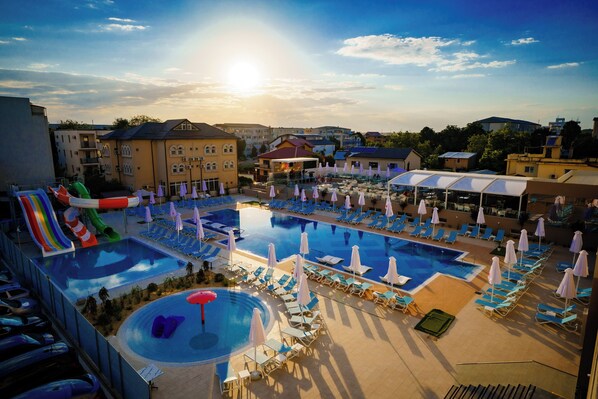 Seasonal outdoor pool, open 10:00 AM to 10:00 PM, pool umbrellas