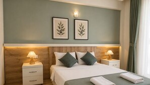 Habitación de hotel ordenada con cama, dos mesitas de noche con lámparas, cabecero de madera e impresiones botánicas enmarcadas en la pared.