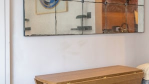 A room with a wooden table and a tiled wall decoration. - Charming Studio moments from Portobello (London)