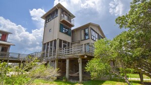 A two-story house with a balcony and a deck.