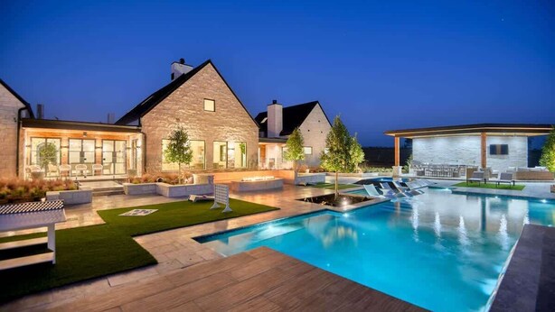 A modern house with a swimming pool, outdoor seating, and a well-lit patio area. - Ultra-Luxe Escape | Sleeps 16 | Minutes to RT (Carmine)