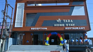 A modern building with a reception and restaurant area, featuring a prominent sign for 'TARA HOME STAY RESTAURANT'. - Maa Tara Homestay (Rishikesh)