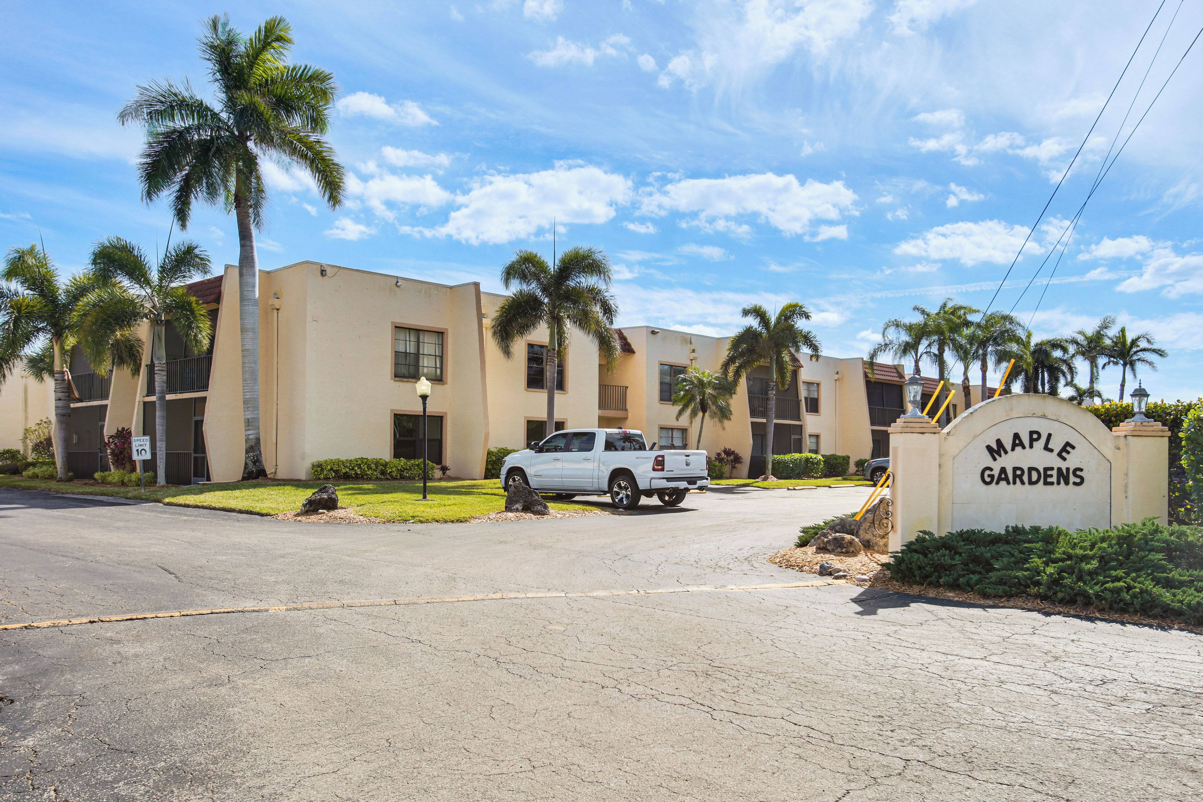 A gated community with a sign reading "Maple Gardens."