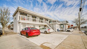 A two-story motel with a white exterior, a balcony on the upper floor, and a staircase leading to the entrance. - Half-block to Beach & Conventions: Wildwood Studio (Wildwood)