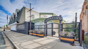 A building with a sign reading "CORKYARD" and a gated entrance. - Half-block to Beach & Conventions: Wildwood Studio (Wildwood)