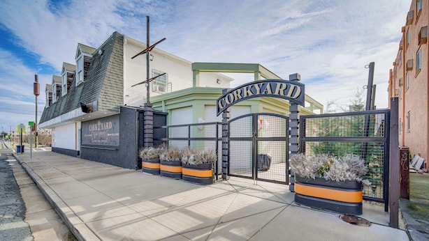 A building with a sign reading "CORKYARD" and a gated entrance. - Half-block to Beach & Conventions: Wildwood Studio (Wildwood)