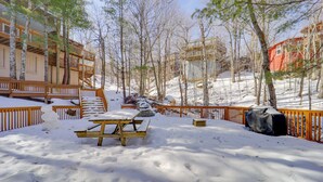 A snow-covered outdoor area with wooden benches and picnic tables, surrounded by trees and wooden fences. - Ski, Hike & More! Couple's Getaway in Beech Mtn (Banner Elk)