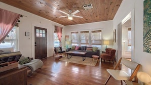 A spacious living room with wooden flooring, a ceiling fan, a sofa set, and a coffee table. - DT 332 Havana Haus (New Braunfels)