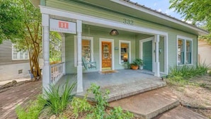 A two-story house with a porch, a sign reading 'HAVANA HOUSE,' and the number 332. - DT 332 Havana Haus (New Braunfels)