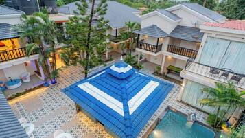 Enjoy the expansive outdoor space with a swimming pool, multiple buildings, and lush surroundings.