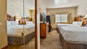 A hotel room with two beds, a dresser, a desk, and a television. - Villa 2055 2 Queen Beds - 1 Bedroom 1 Bath No Kitchen 1 Villa (Midway)