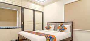 A hotel room with a bed, a wardrobe, and a window. - RS LIVING (Hyderabad)