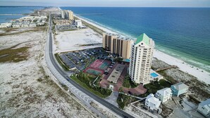 An aerial view of a coastal hotel with multiple buildings, a parking lot, and a beach. - 🌴🌞🌴Beachfront Condo | Seasonally Heated Pool | Navarre Towers 1205🌴🌞🌴 (Navarre Beach)