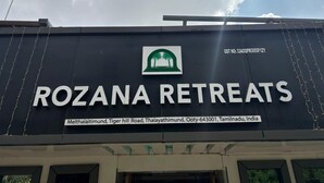 A sign for Rozana Retreats with a logo, address, and GST number. - Rozana Retreat (Ootacamund)