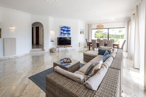 Relax in style with a comfortable sofa set and dining area, perfect for unwinding or socializing.