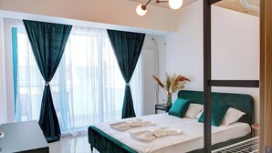 A modern bedroom with a four-poster bed, a bedside table, and a window with sheer curtains. - Cnc Zev Apartment (Navodari)