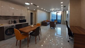 A modern apartment with a dining area, kitchen, and living space. - King David standard two bedroom 24 (Tbilisi)