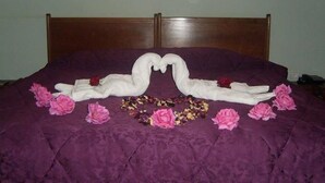 A bed with a purple bedspread and a wooden headboard. - Résidence Des 4 Chemins (Beni Mellal)