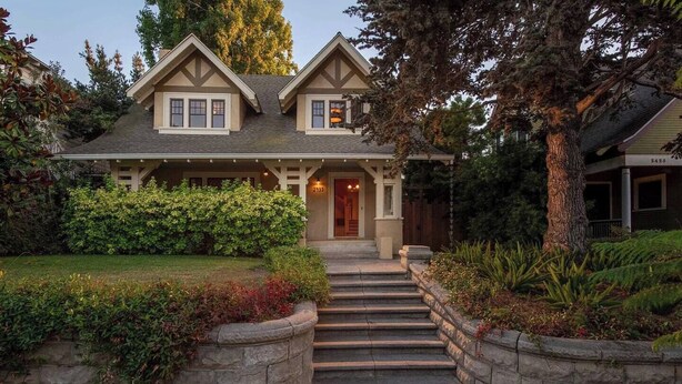 A two-story house with a stone staircase leading to the front door, surrounded by well-maintained landscaping and a large tree. - B Street Historic House-Min to Convention Cnr, Gaslamp, Balboa-Comp. Bikes (San Diego)