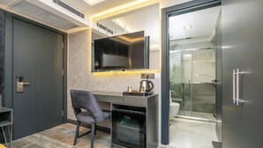 A modern bathroom with a glass shower enclosure, a toilet, and a sink. - 216 Silver Suite (Tuzla)