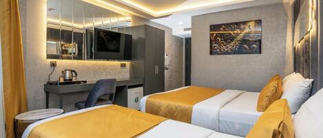 A hotel room with two beds, a desk, a chair, a television, and a painting on the wall.