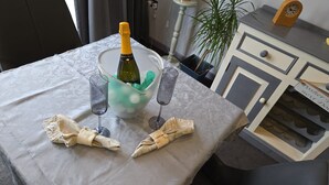 A table with a bottle of champagne, two glasses, and napkins. - Haven Lodge Kirkby In Furness -  a lodge that sleeps 2 guests  in 1 bedroom (Kirkby in Furness)