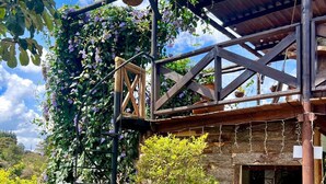 A rustic wooden structure with a wooden staircase leading to a covered area.