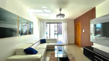 Luxury Suite | Living area | 42-inch Smart TV with cable channels