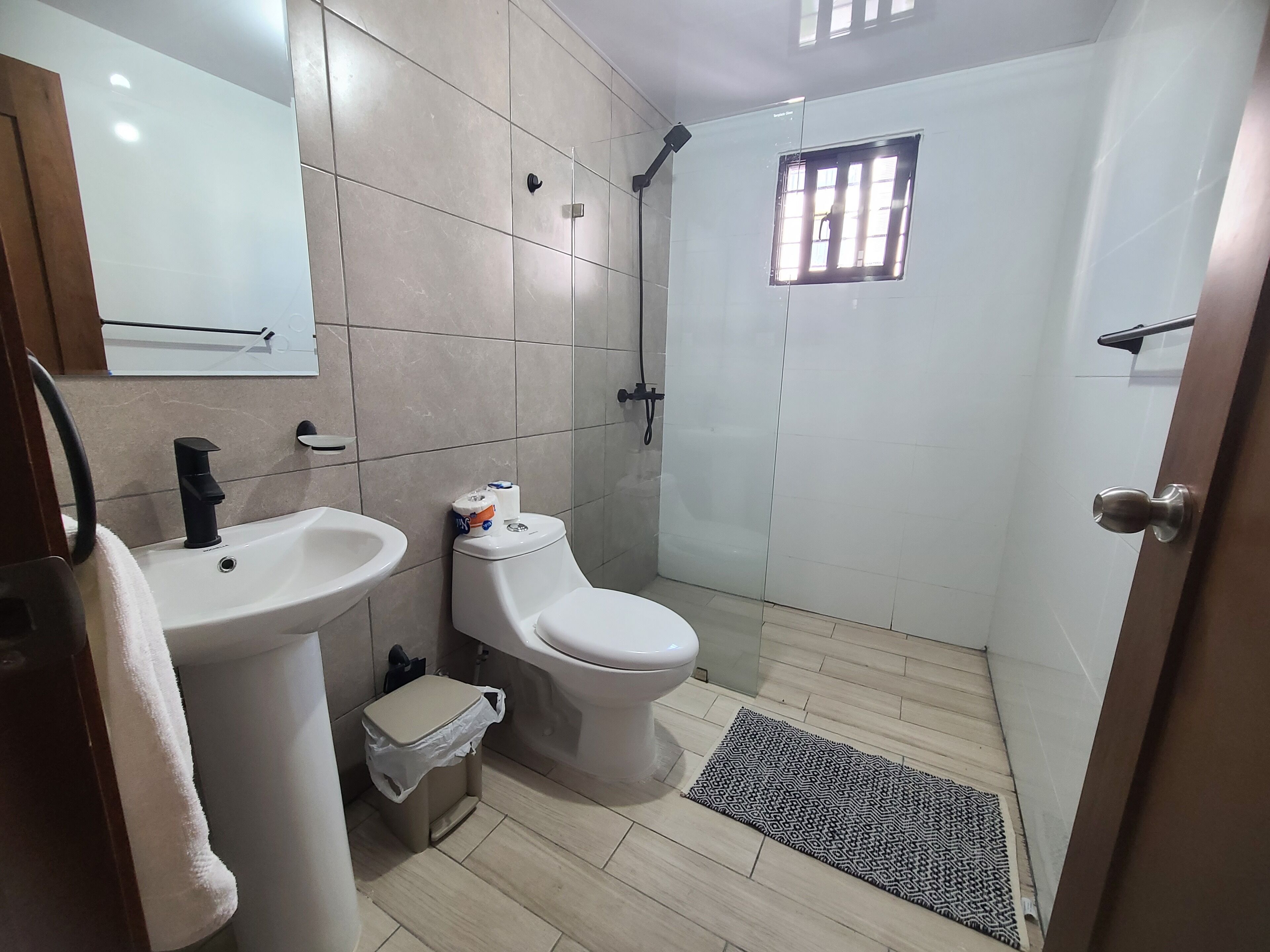 A bathroom with a sink, toilet, and shower.