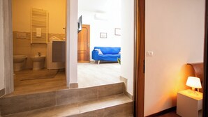 A staircase leading to a bathroom with a towel rack, a sink, and a toilet. - Dimora Stella  -apeliving- Pellestrina Ve (Venice)