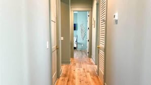 A hallway with wooden flooring and light-colored walls. - Watermark Way -Private pool- Elevator Private Beach access (Port St. Joe)