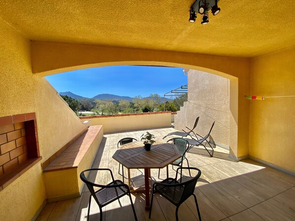 Enjoy dining or socializing in this outdoor space with a mountain view.