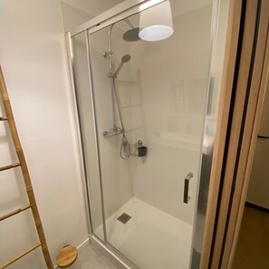 Enjoy a refreshing shower experience with a handheld and overhead showerhead, plus a convenient stool for added comfort.