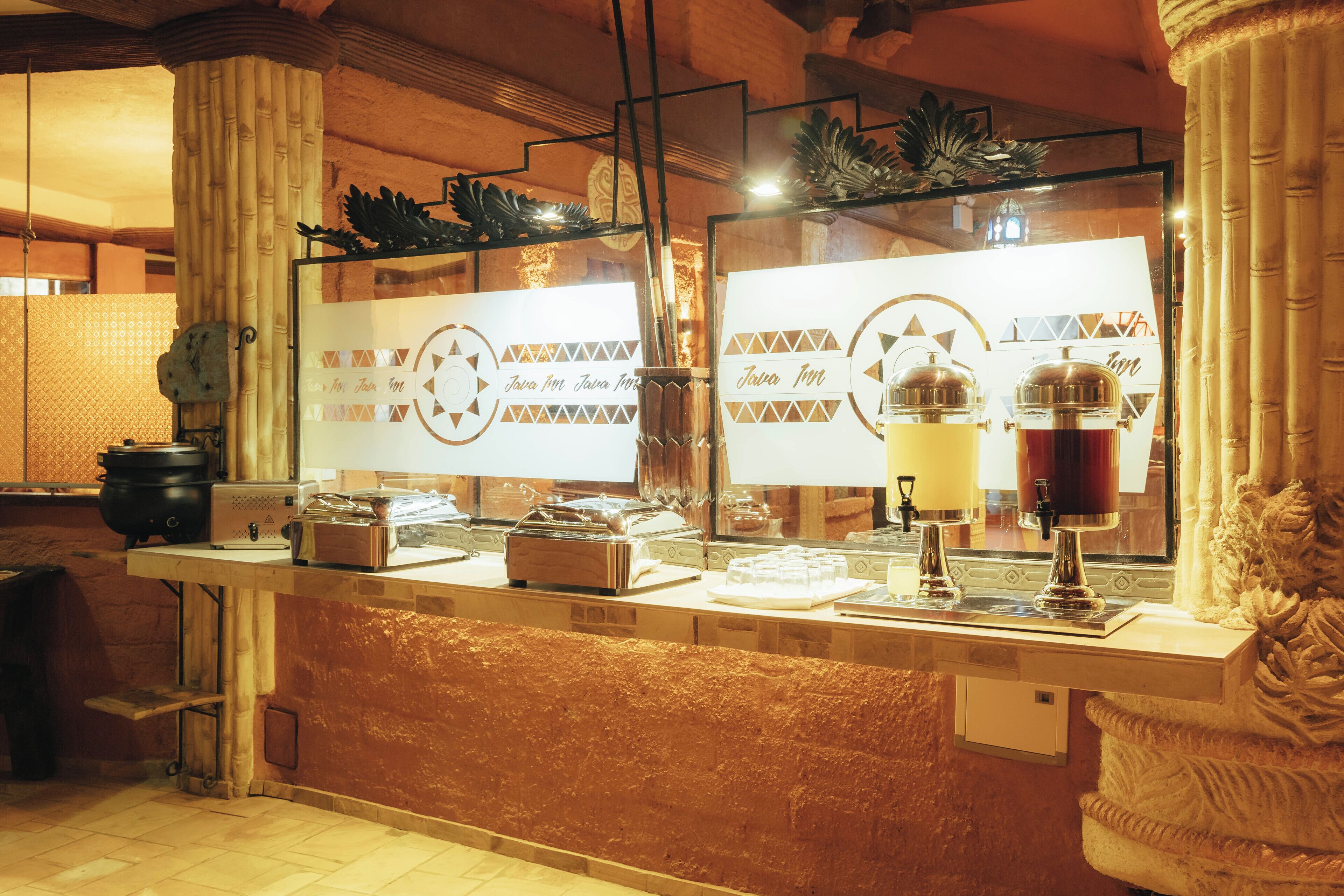 A buffet counter with a variety of food items and a coffee machine.