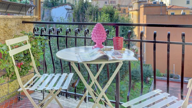 A balcony with a table, chairs, and a decorative item. - Vatican Loft with Balcony -Home and More (Rome)