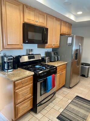 Enjoy cooking in this well-equipped kitchen with a refrigerator, microwave, gas stove, coffee maker, and toaster.