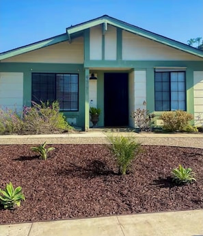 Stylish single-story home with a gabled roof and welcoming entrance.